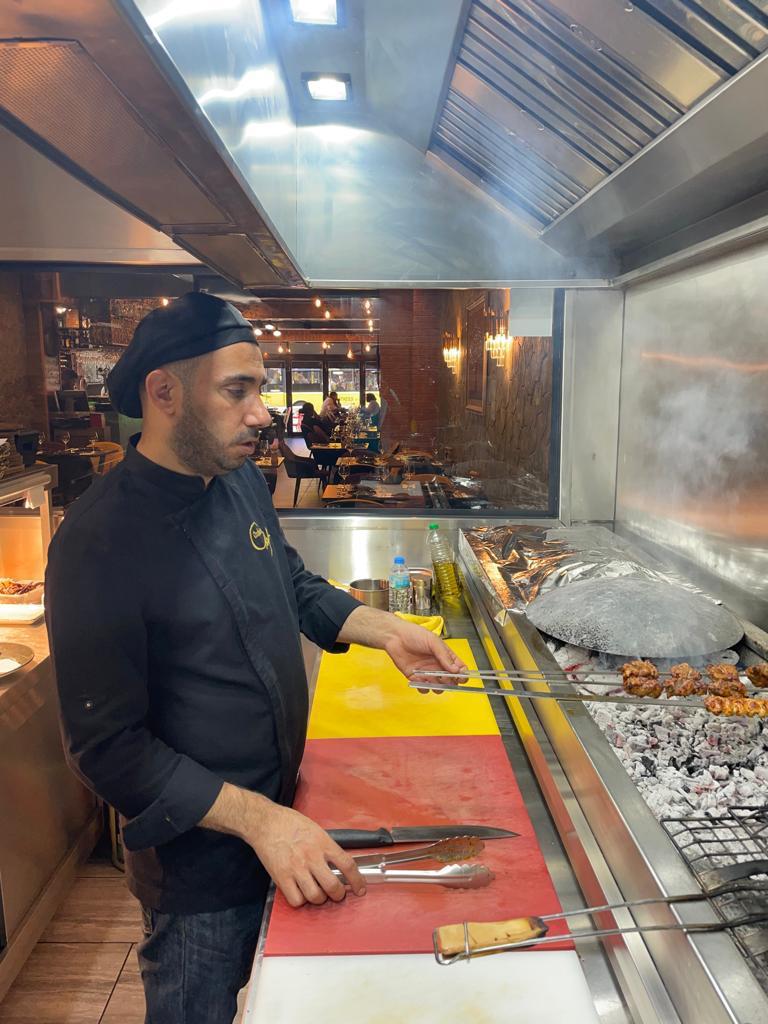 Chef Mehmet Özdemir cooking over charcoal