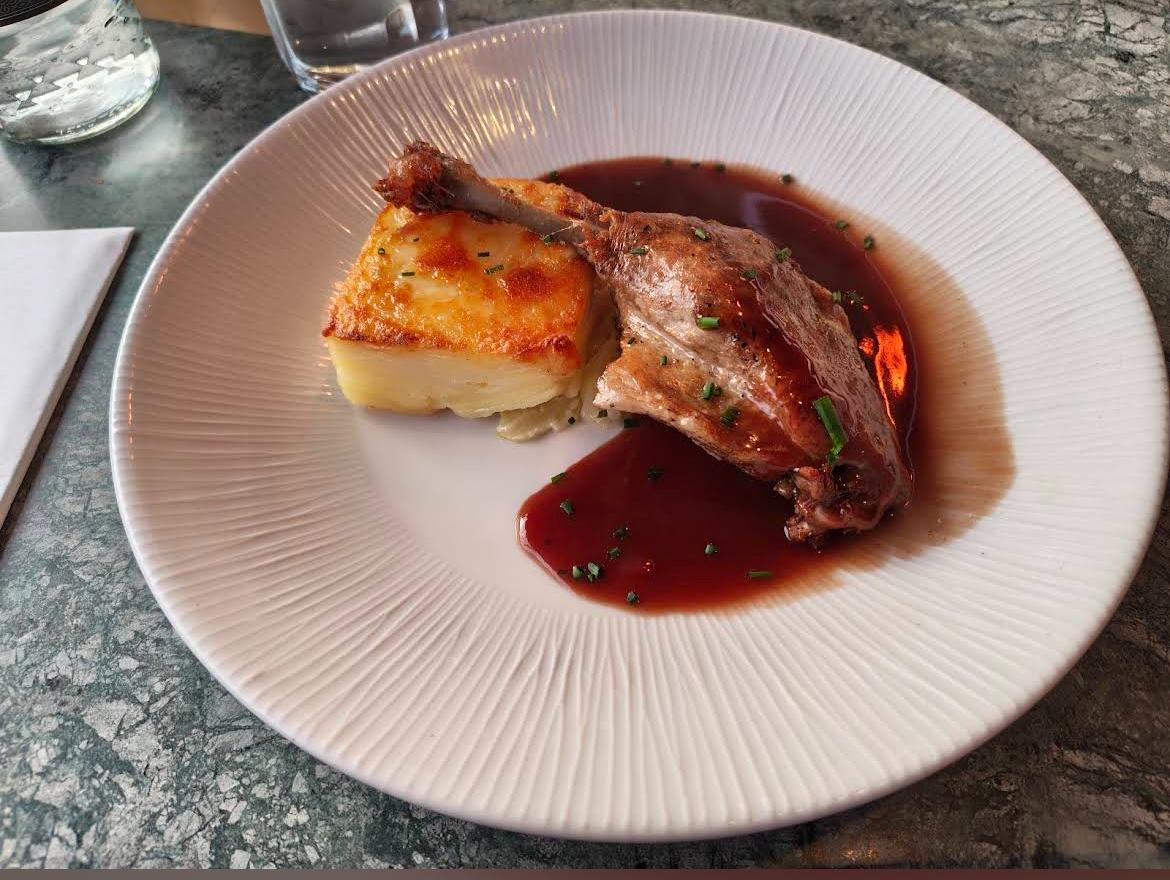 Confit duck with layered potato and jus